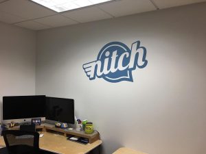 Nitch Creative's logo on an office wall