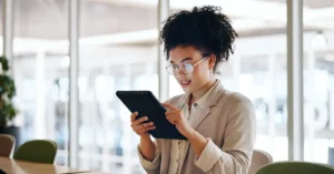 An SEO specialist reviewing KPIs on a tablet.