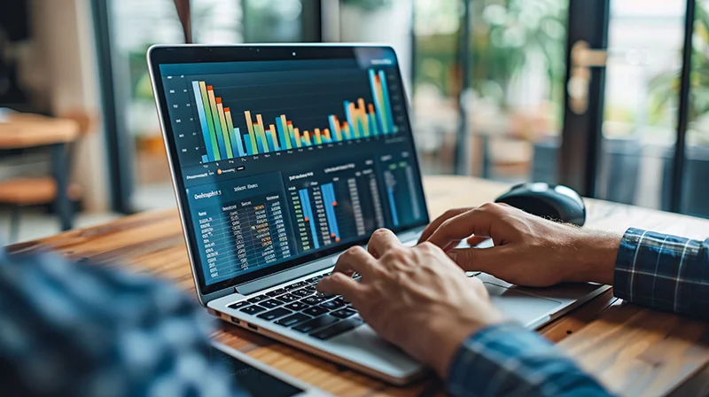 A digital marketer analyzing website traffic data on a laptop