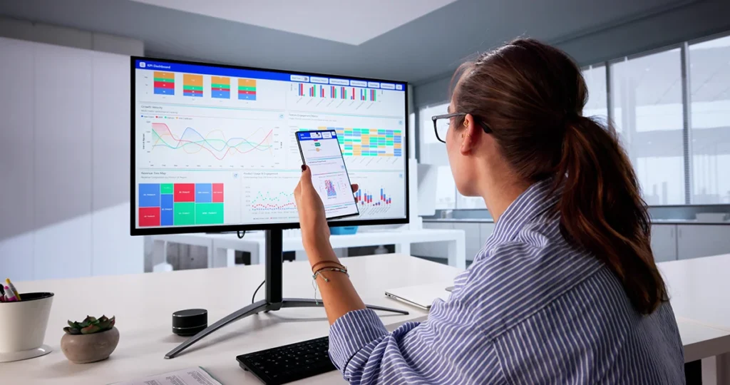 Businesswoman Analyzing Key Performance Indicators On Computer Dashboard