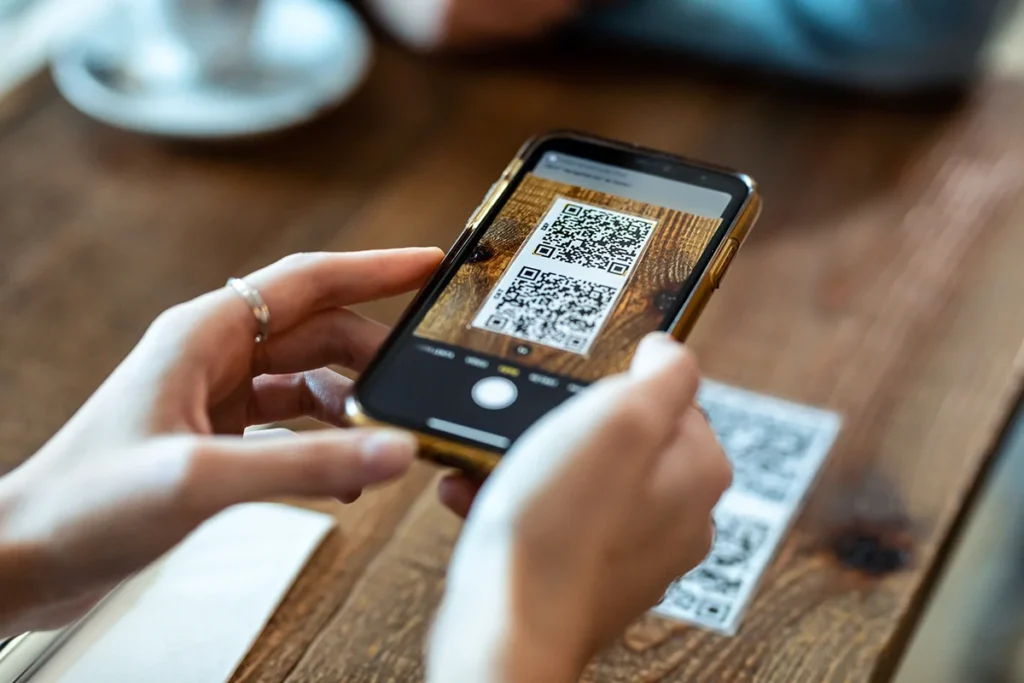 Young woman hands using the smart phone to scan the QR code