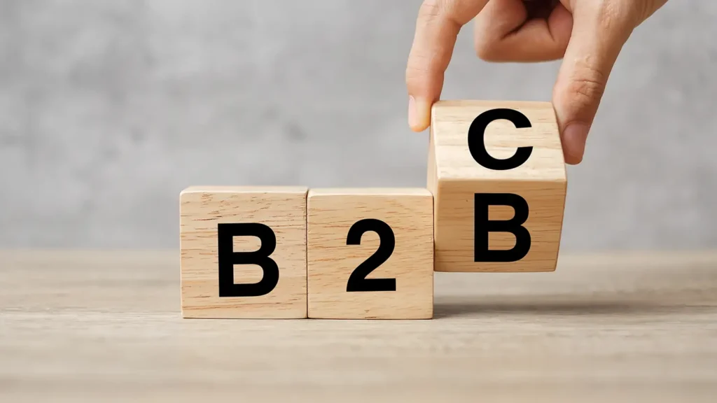 hand changing wooden cube block from B2C to B2B. E Commerce, marketing and strategy concepts